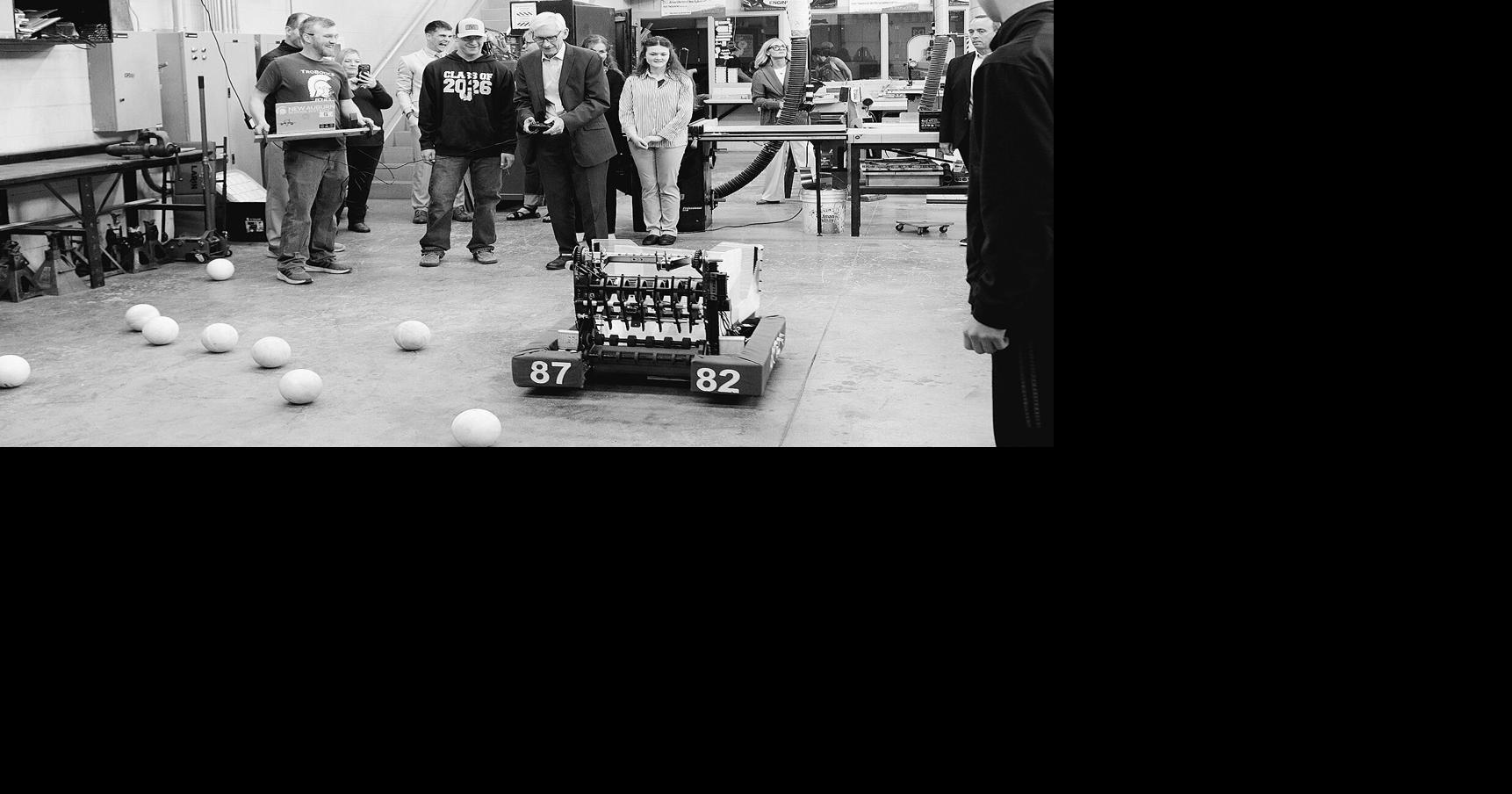 Governor Evers runs robot during visit to New Auburn School
