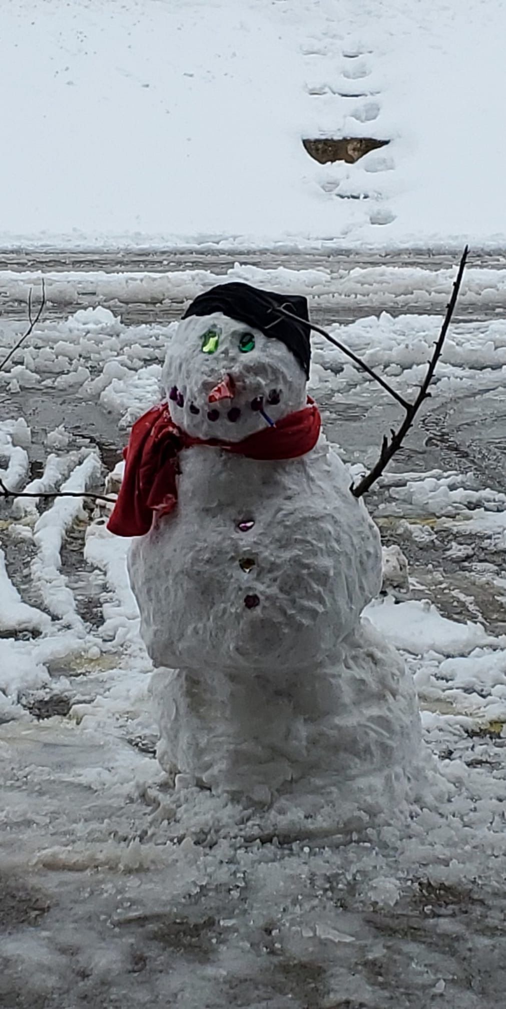 A snowman waves hello