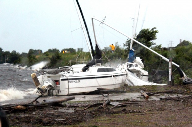 Storm sinks boat damages home