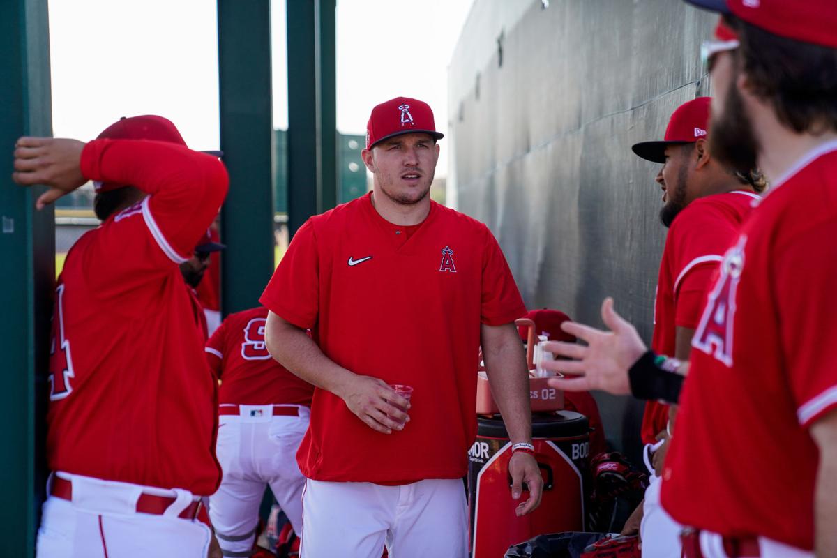 The Los Angeles Angels' Mike Trout, middle, chats with teammates during spring training at Tempe Diablo Stadium in Tempe, Ariz., on February 18, 2020.