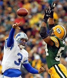 MORRY GASH / THE ASSOCIATED PRESS — Detroit Lions quarterback Joey  Harrington tries to pass around the outstretched arms of the Packers' Nate  Wayne Sunday in Green Bay. Wayne intercepted the pass.