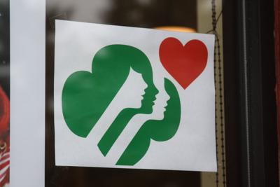 Donations Accepted For Victims Of Chippewa Falls Girl Scout Troop - a poster in the window of the chippewa falls main street office in chippewa falls to show support for the deceased girl scouts and mother