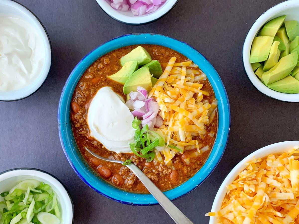 Lots of crunchy, sharp and creamy toppings turn a simple bowl of beef and chili into dinner in an instant.