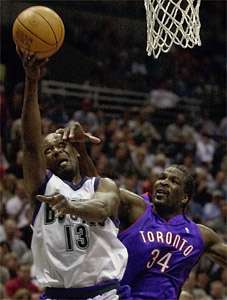 THE ASSOCIATED PRESS —Toronto Raptors' Charles Oakley fouls Milwaukee  Bucks' Glenn Robinson as he goes up