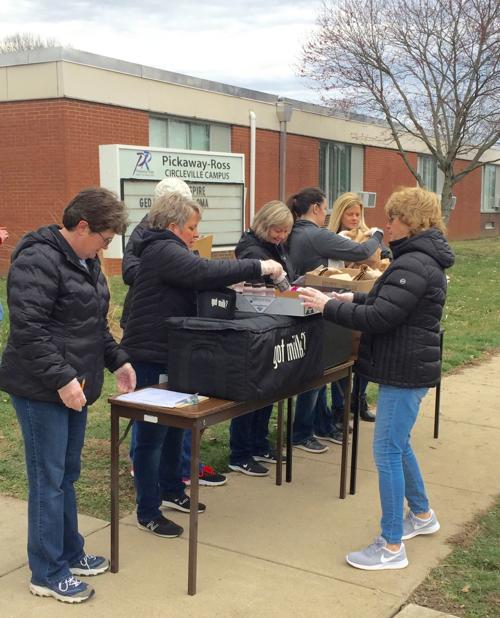 Volunteers serve grab-n-go lunches