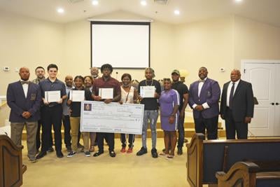 Omega Psi Phi presents $8,000 in scholarships