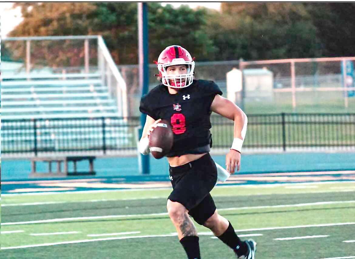 Quarterback's son hilariously wears opponent's jersey