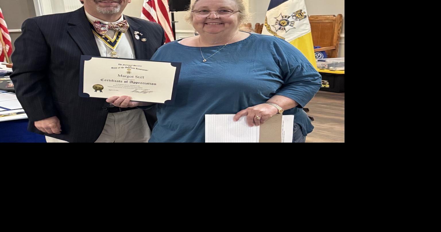 SAR presents Certificates of Membership to Margot Still and Douglas Campbell
