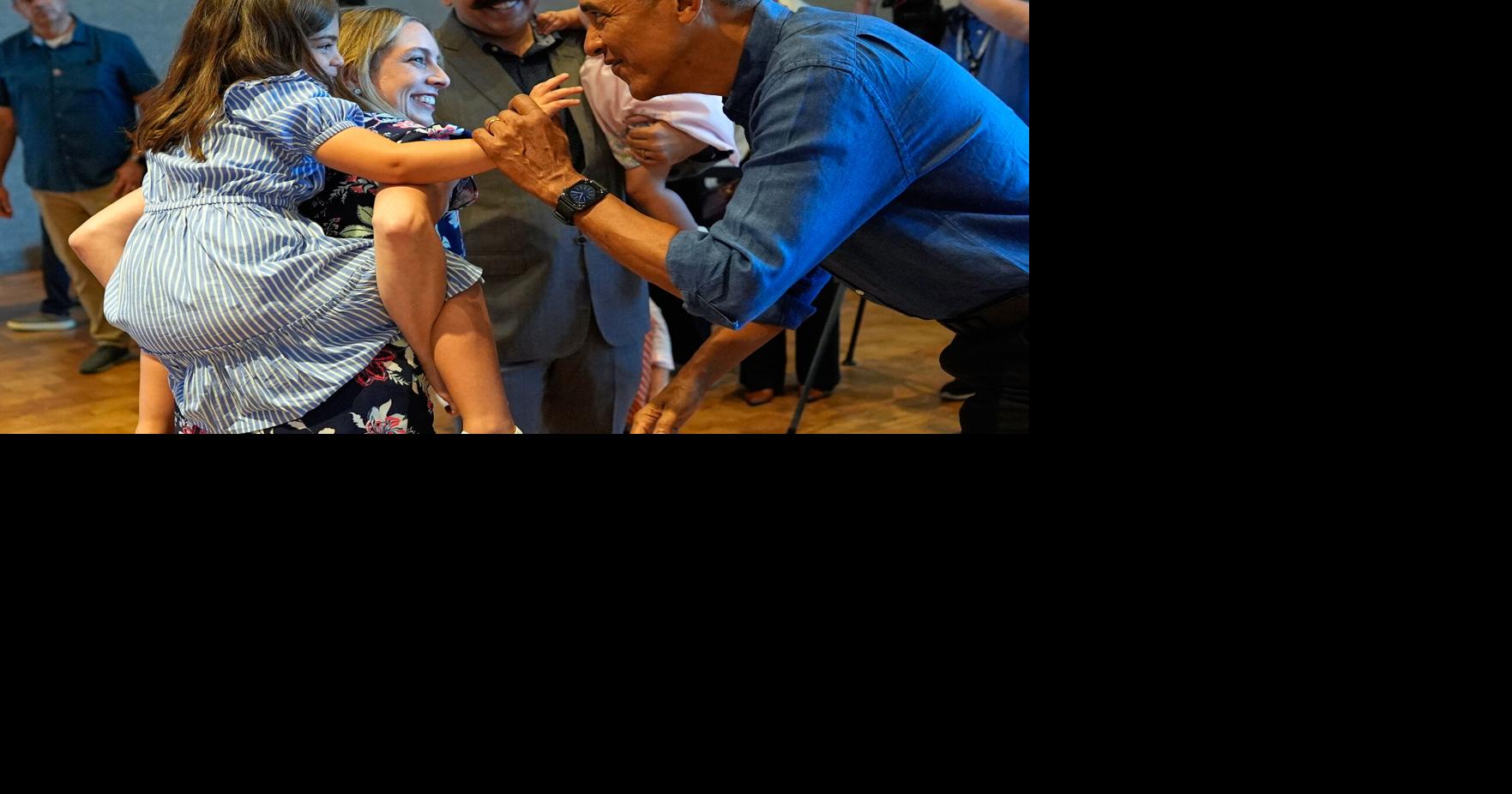 Barack and Michelle Obama surprise first visitors to newly opened presidential center