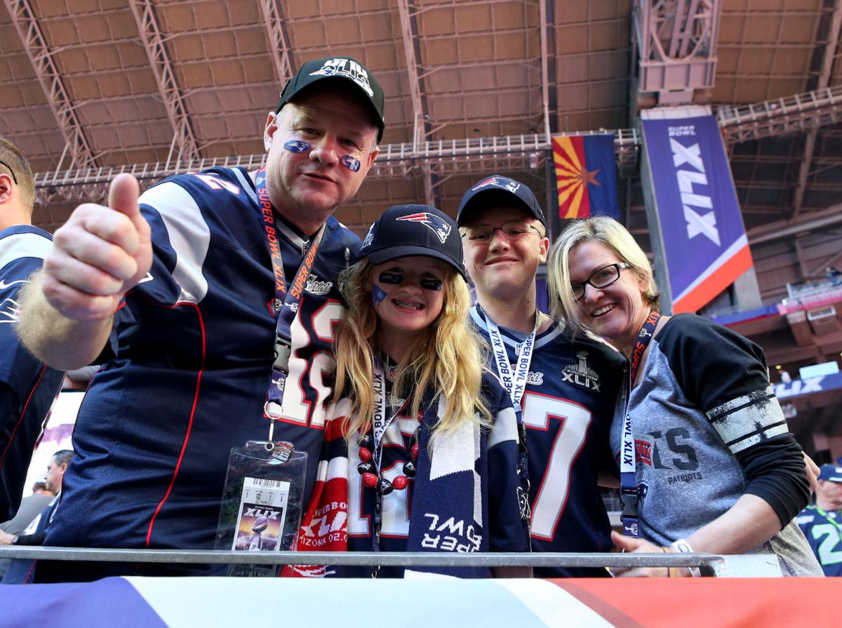 Steve Gorham, of Andover, Massachusetts, gives a thumbs up with his family Brigitte, 12, Oliver, 16, and wife Dodie before the start of Super Bowl XLIX.