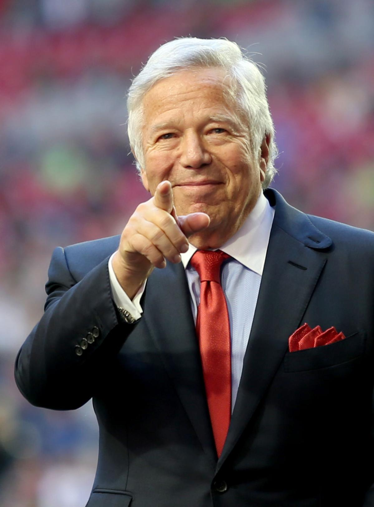 New England Patriots owner Robert Kraft points to the crowd as he acknowledges fans as he comes onto the field before the start of Super Bowl XLIX in Glendale, Ariz.