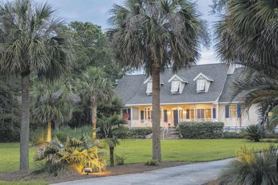 Beautiful southern style house lit up at twilight.