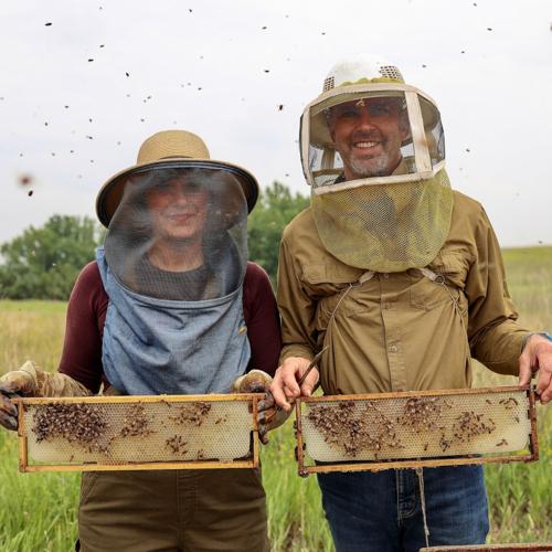 Suchans holding bee frames