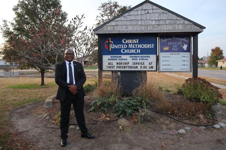 Rev. Sammy Karanja by church sign