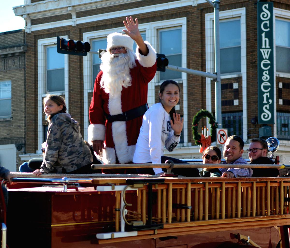 Santa and his friends arrive on the back of a vintage firetruck Saturday afternoon in downtown Columbus