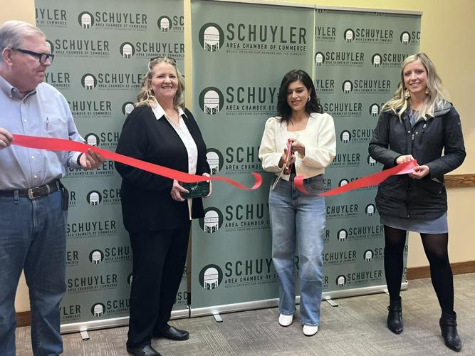 Perla cutting ribbon indoors