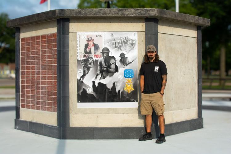 Dillon Krueger at Colfax County Veterans Memorial with artwork