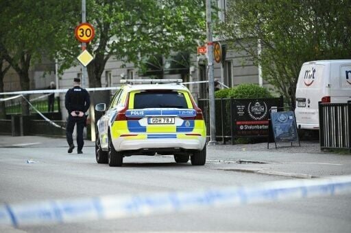 Police officers cordoned off the scene after the shooting in Uppsala