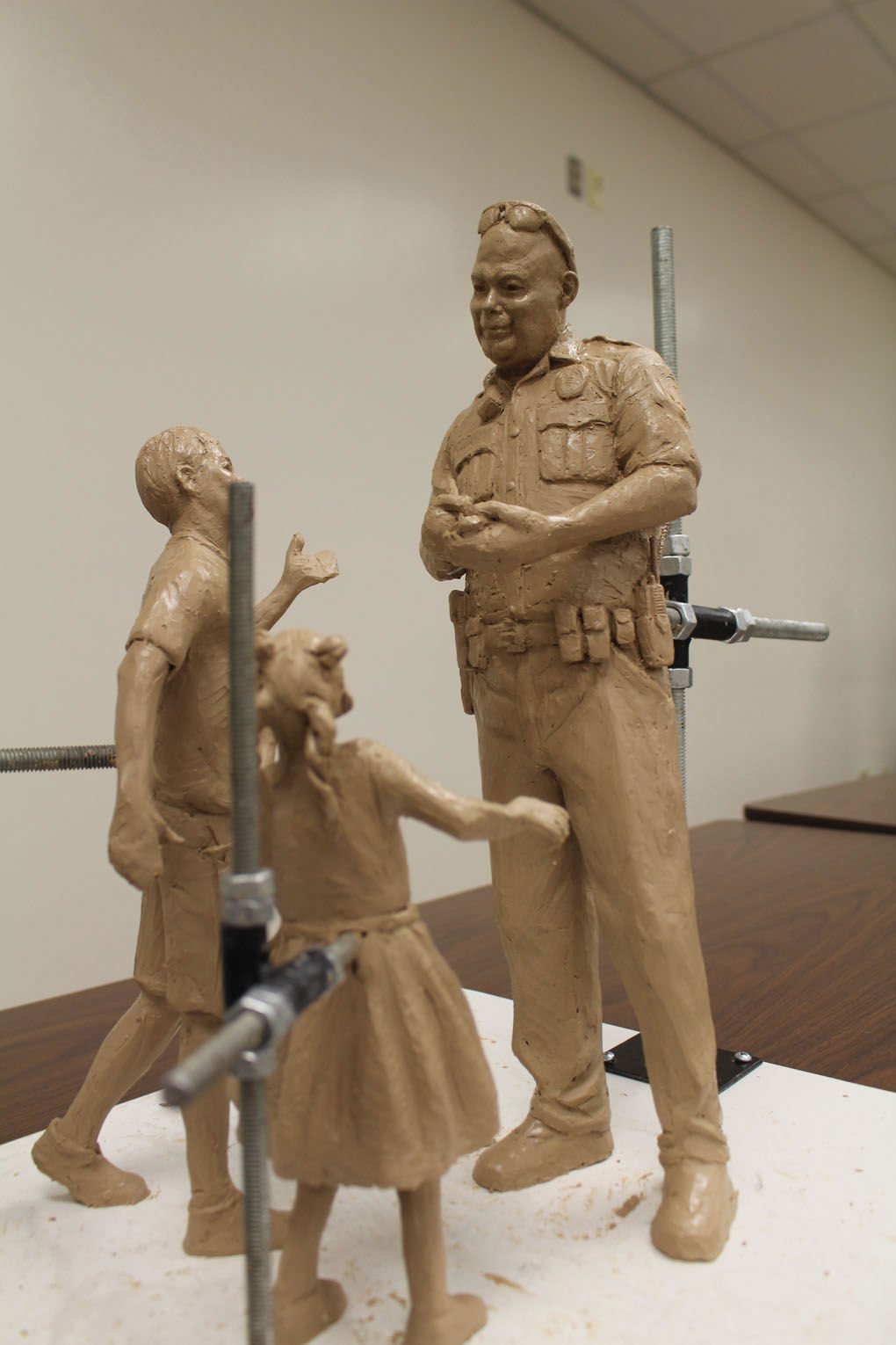 A bronze statue of Officer Brent Thompson with two children is in the works for downtown