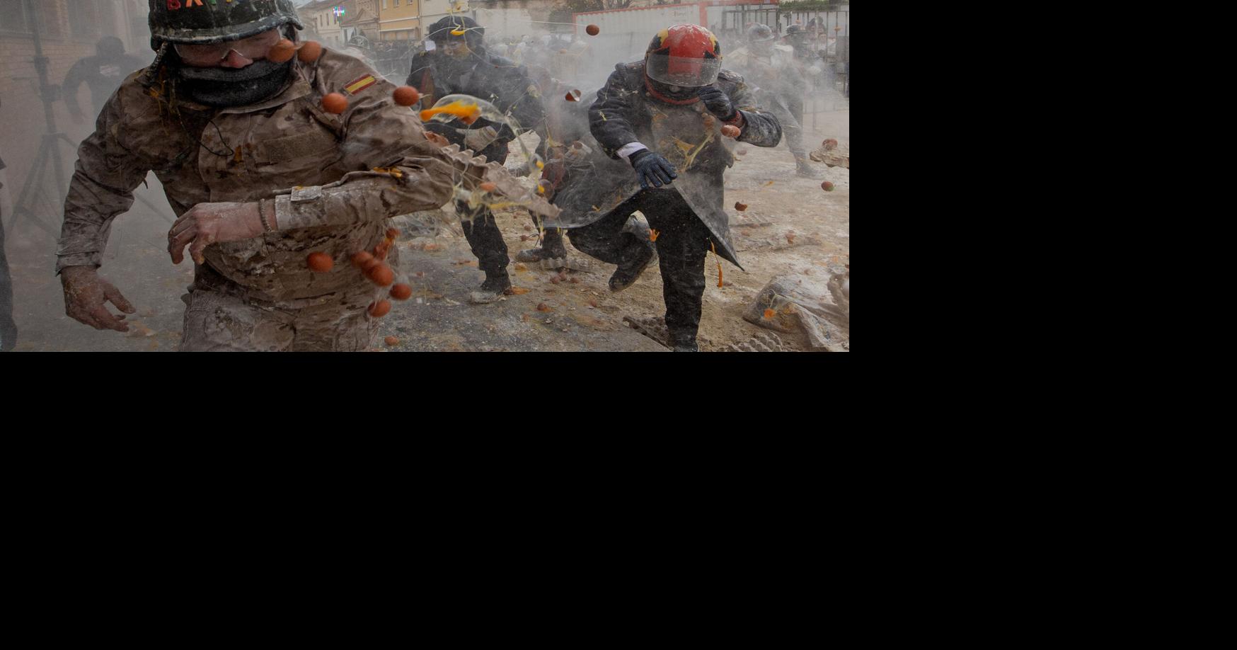 Photos show flour, eggs and firecrackers flying at Spain's Els Enfarinats festival