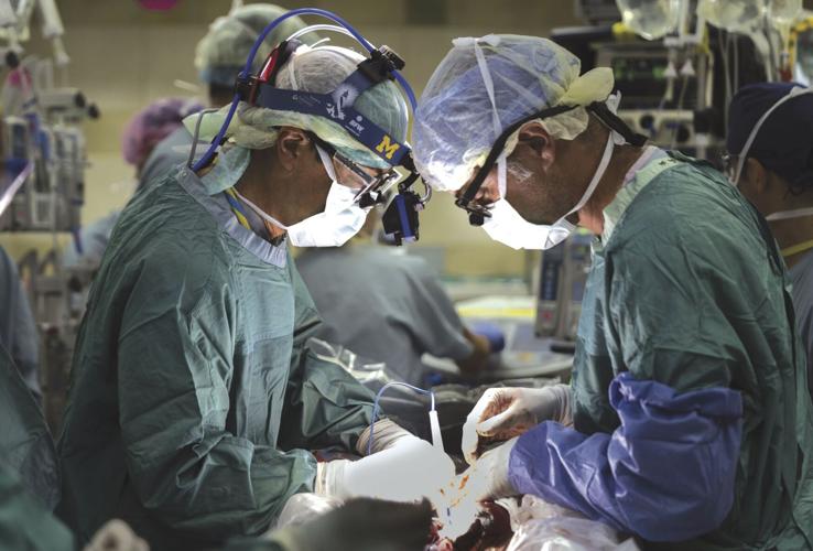 Two surgeons, WCHS graduates, operate together to separate conjoined twins