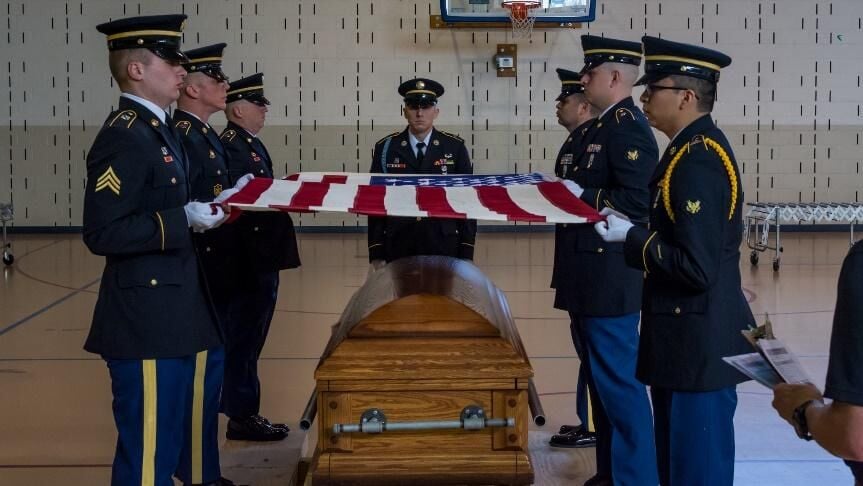Funeral and Honors Program Soldiers train on folding an American Flag over a casket during an April 2018 course at Camp Lincoln in Springfield, Illinois. The Illinois Army National Guard’s Funeral and Honors Program provided military funeral rites for m...