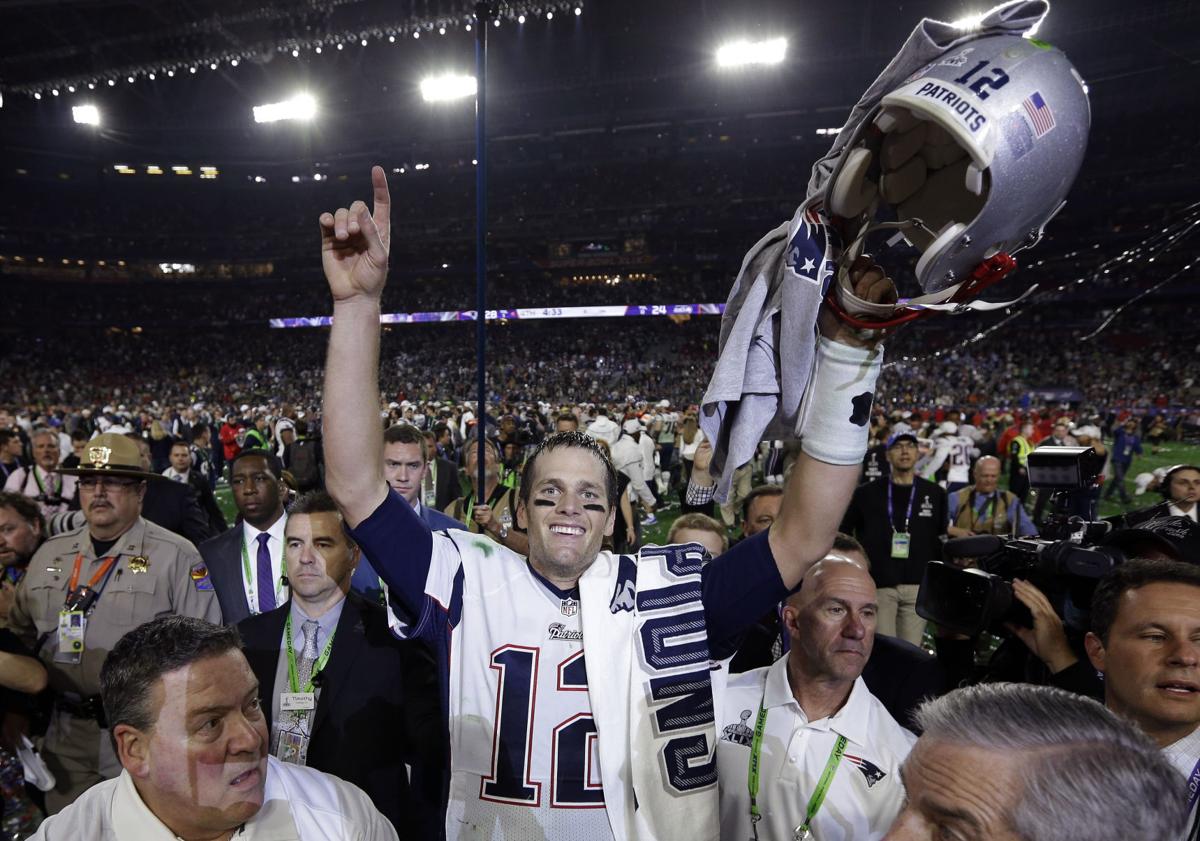 New England Patriots quarterback Tom Brady walks on the field during Media  Day at the University of Phoenix Stadium in Glendale, Arizona, on January  29, 2007. Super Bowl XLII will feature the