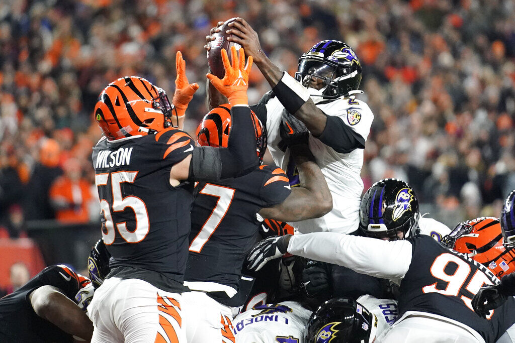 Baltimore Ravens quarterback Lamar Jackson (8) takes to the field with a  member of the military as part of Salute to Service before an NFL football  game against the Carolina Panthers, Sunday