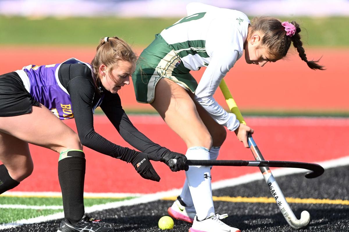 Side view of a Caucasian female field hockey player, during a