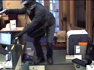 Helmeted gunman jumped bank counter in robbery