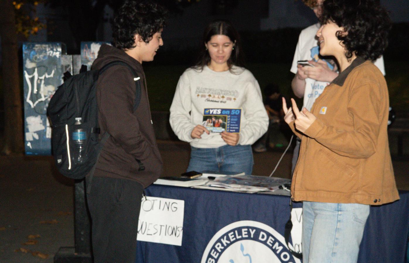 A member of Cal Berkeley Democrats assists students