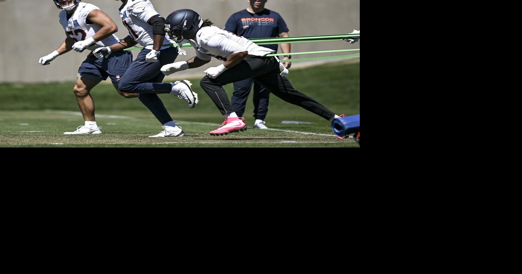 The Denver Broncos' Jonah Elliss, Que Robinson and Nik Bonitto run through drills during OTAs at the Broncos Park in Centennial, Colorado, on June 11, 2026.