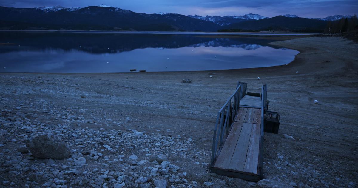 Dry lakebed is exposed near Indian Peaks Marina during low water levels at Lake Granby on April 7, 2026, near Granby, Colo. Lake Granby, a reservoir in the upper Colorado River system, is fed by the Colorado River.