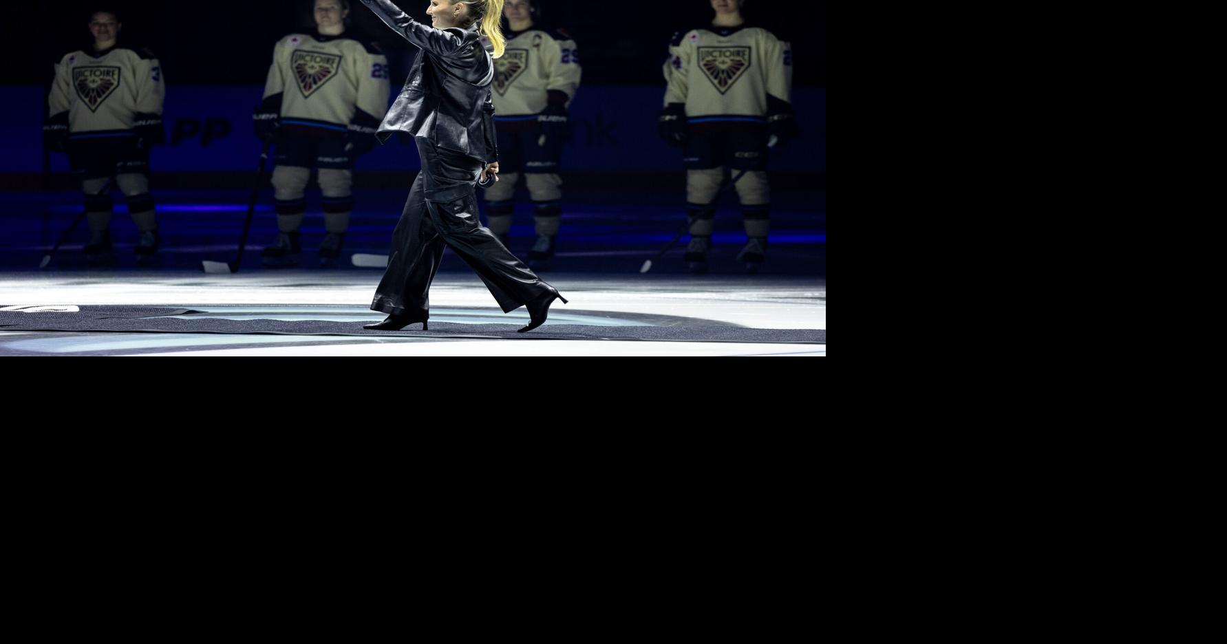 Seattle Kraken assistant coach Jessica Campbell waves to the crowd as she walks on the ice for a ceremonial puck drop before a PWHL hockey game between the Boston Fleet and Montreal Victoire on Sunday, Jan. 5, 2025, in Seattle.