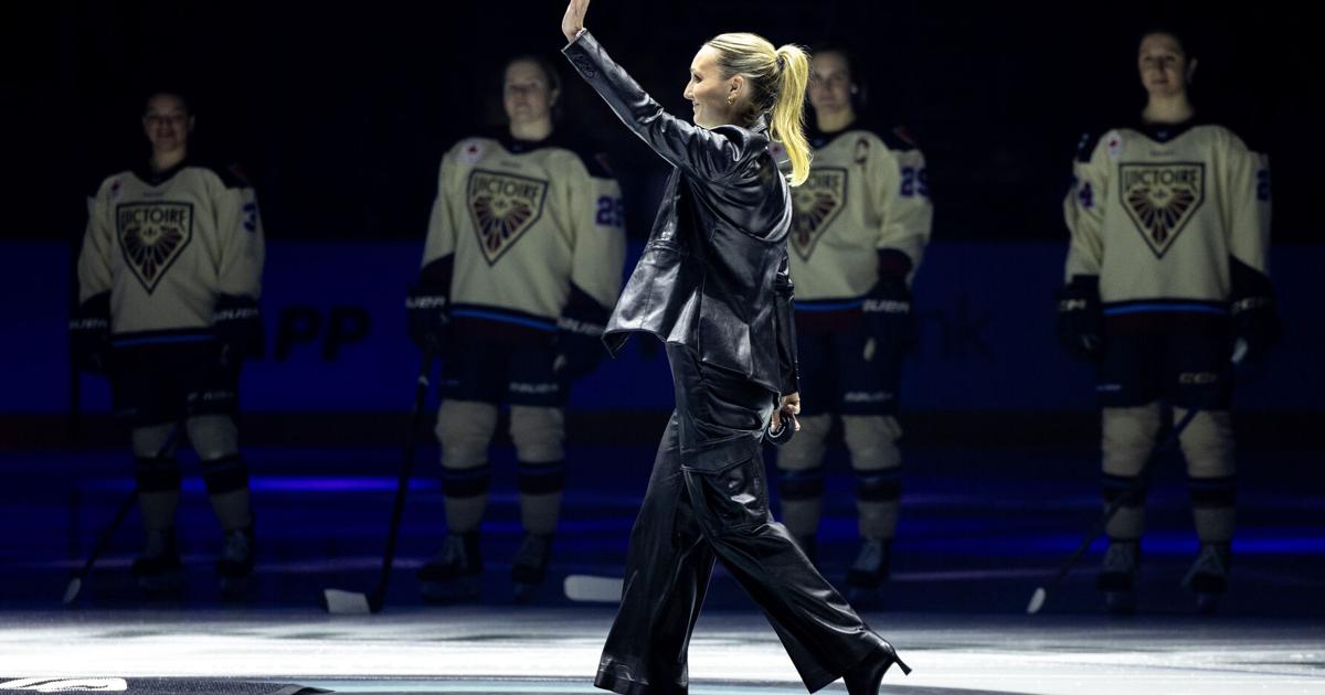 Seattle Kraken assistant coach Jessica Campbell waves to the crowd as she walks on the ice for a ceremonial puck drop before a PWHL hockey game between the Boston Fleet and Montreal Victoire on Sunday, Jan. 5, 2025, in Seattle.