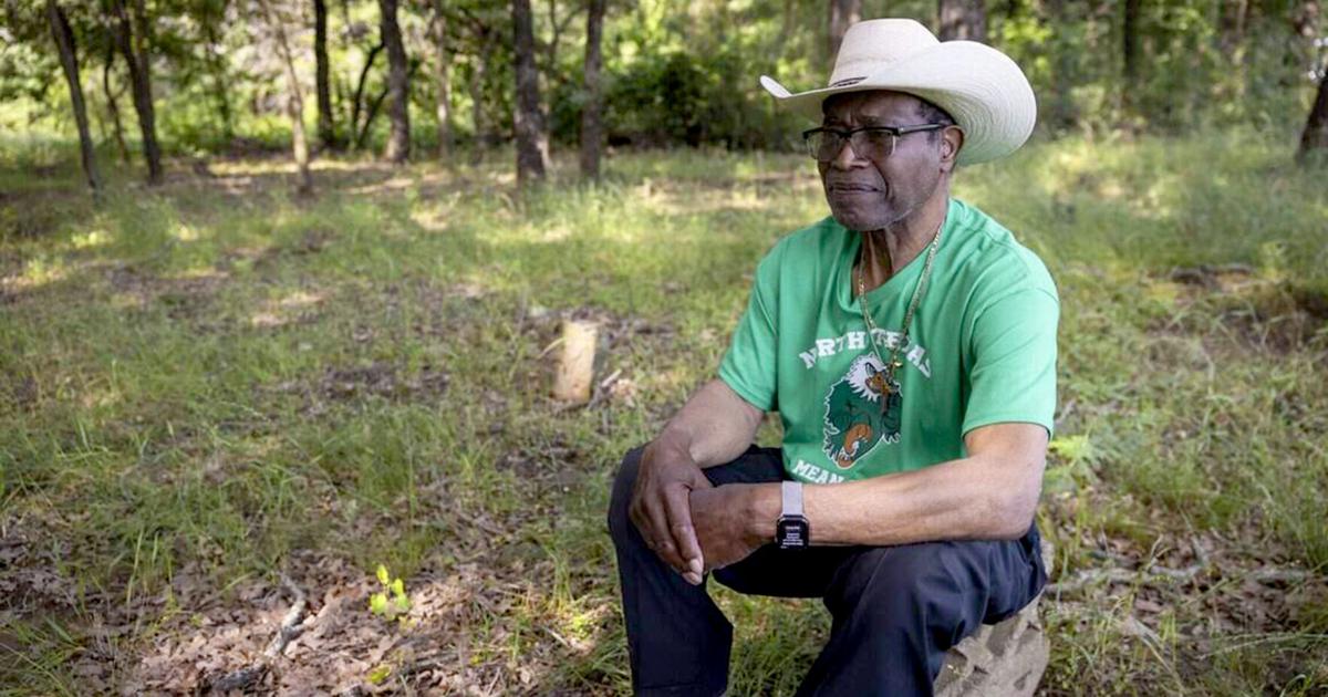 Activist Willie Hudspeth reflects at St. John's Cemetery on Saturday, May 9, 2026 in Denton, Texas.“ I'm just sitting here on this stone and just looking out here reflecting of the people that had no voice.