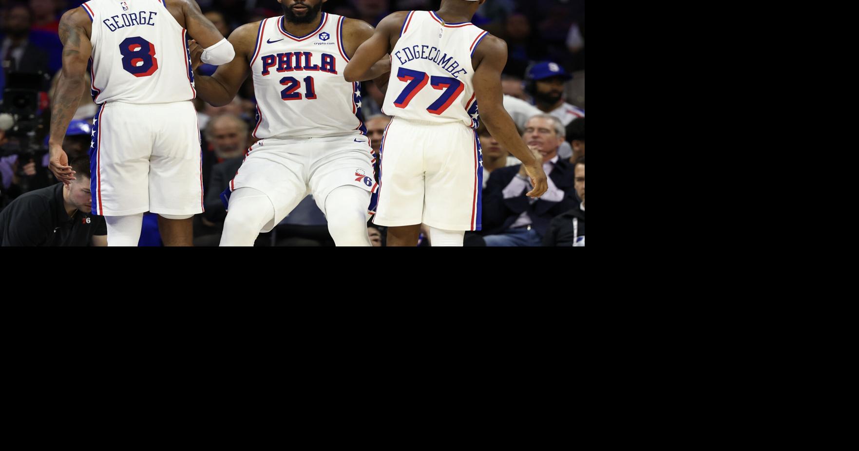 The Philadelphia 76 ers' Joel Embiid is helped up by Paul George and VJ Edgecombe after getting fouled during the fourth quarter of a Game 6 win against the Boston Celtics on Thursday, April 30, 2026, in Philadelphia.