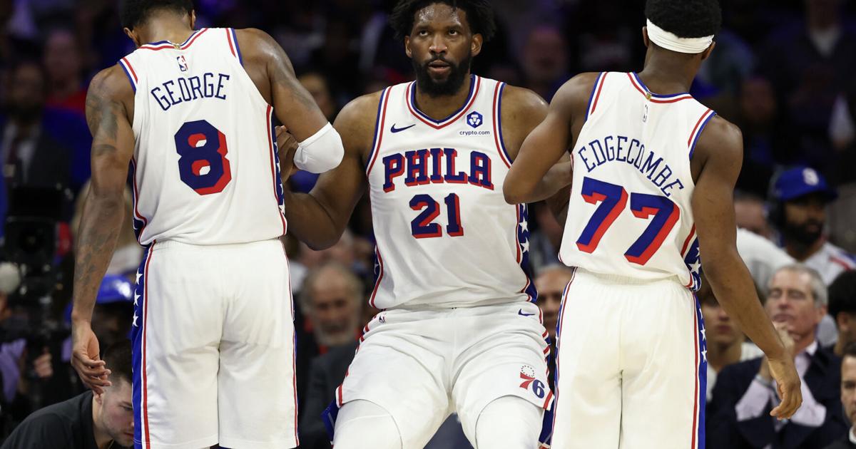 The Philadelphia 76 ers' Joel Embiid is helped up by Paul George and VJ Edgecombe after getting fouled during the fourth quarter of a Game 6 win against the Boston Celtics on Thursday, April 30, 2026, in Philadelphia.