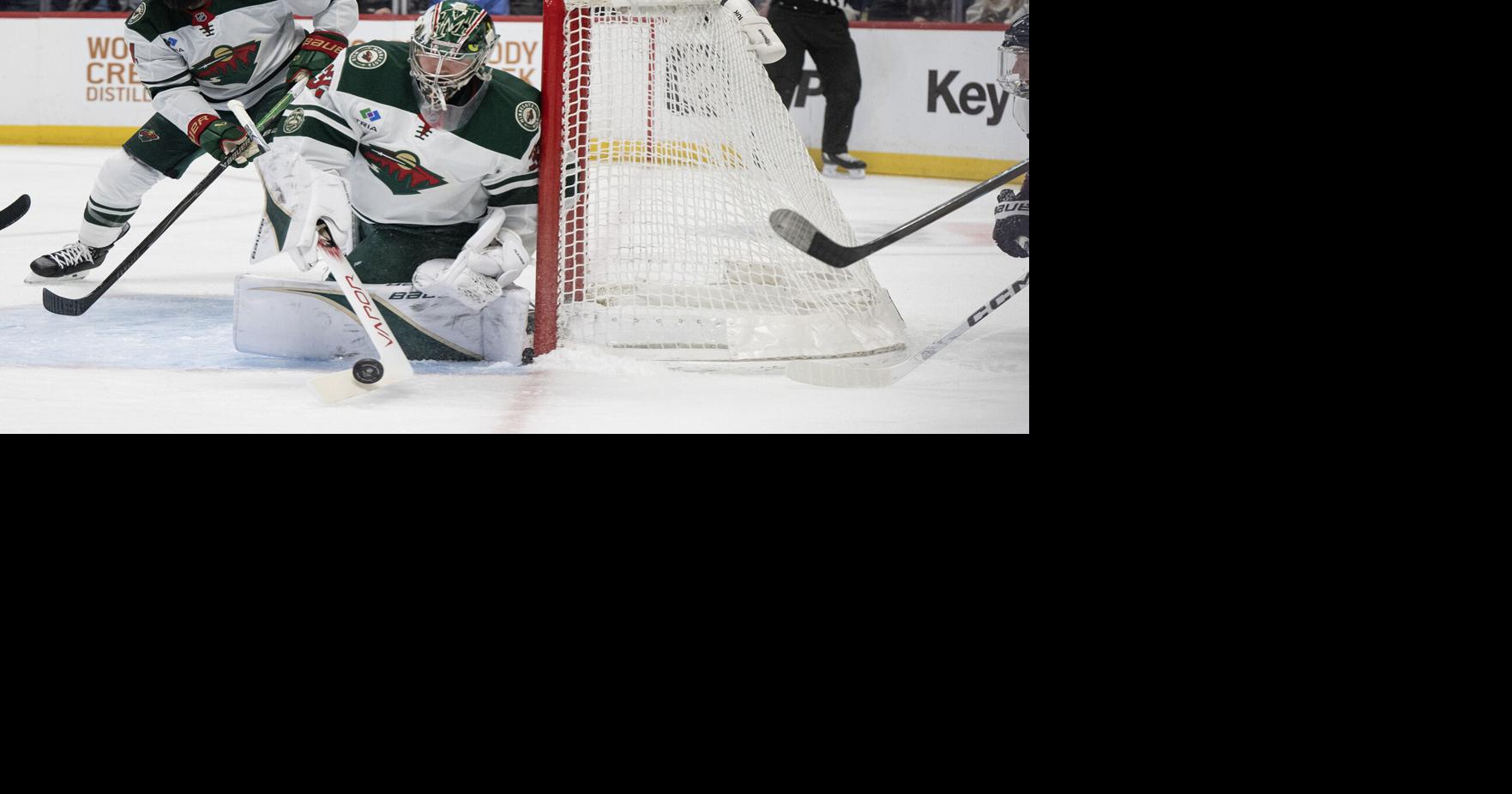 Filip Gustavsson of the Minnesota Wild swats away a puck during a game against the Colorado Avalanche on Thursday, Feb. 26, 2026, at Ball Arena in Denver.