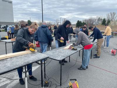 Pioneer employees build beds for Capital Region children in need