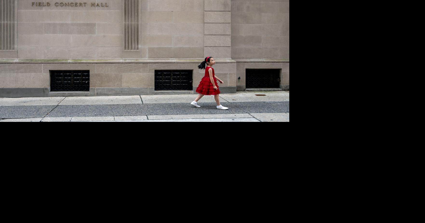 Olivia Li walks toward the entrance to 1726 Locust St., the one-time mansion that is home to the Curtis Institute of Music.