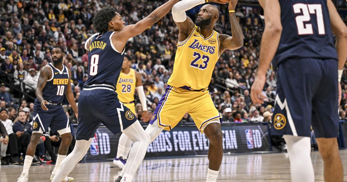 LeBron James of the Los Angeles Lakers works against Peyton Watson of the Denver Nuggets during the third quarter at Ball Arena in Denver, Colorado on Tuesday, Jan. 20, 2026.