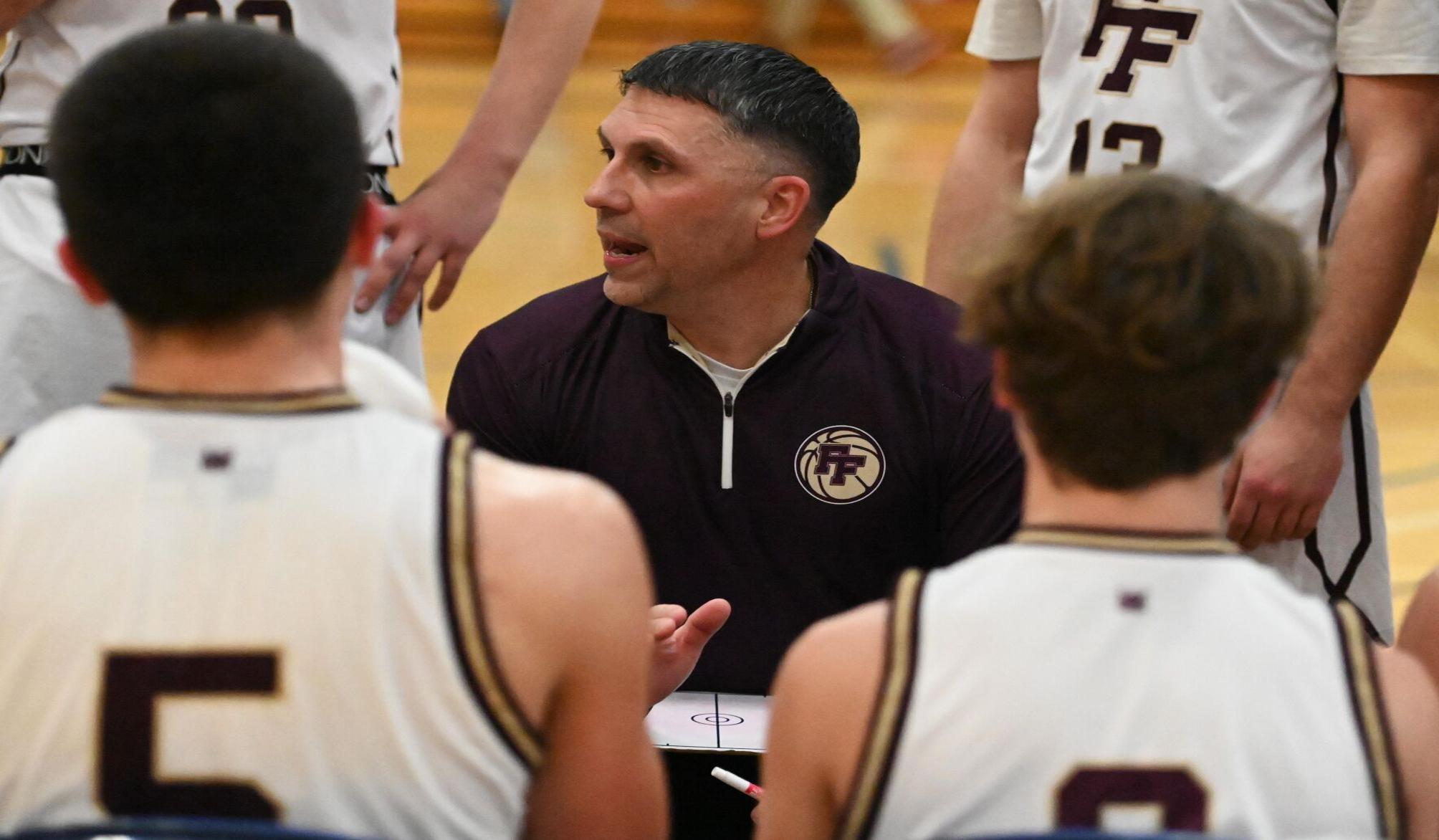 Coach Eric Wilson strategizing