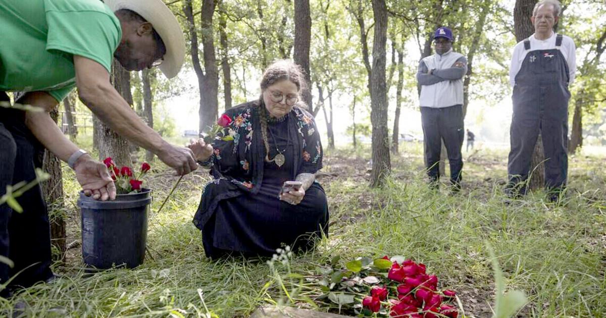 Jessica Luther Rummel reads the names of those known to be buried in St. John's Cemetery on Saturday, May 9, 2026, in Pilot Point, Texas.