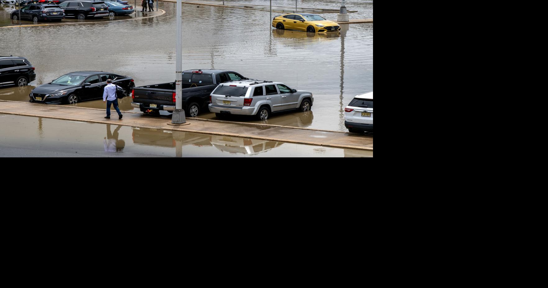 Oscar Parra makes his way to his car in the flooded parking lot at the Ferry Avenue PATCO station in Camden earlier this month.