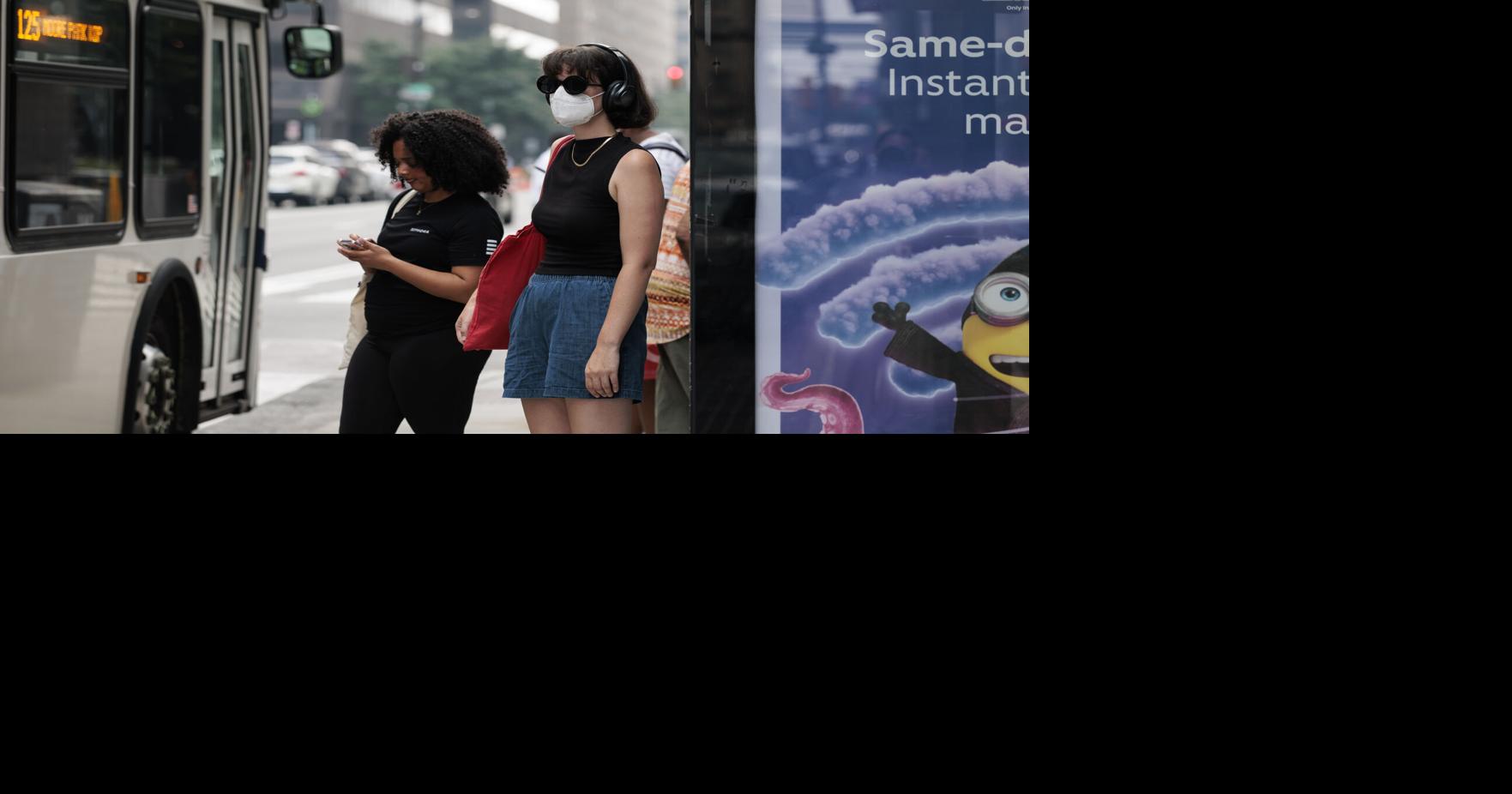 Penn State graduate student Ray Boone waits for the bus with a face mask on because of the air quality on Thursday, July 16, 2026.