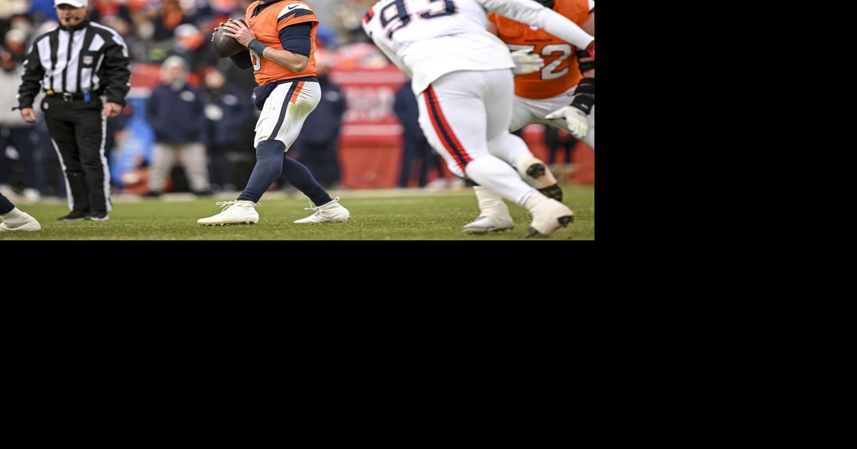 Jarrett Stidham of the Denver Broncos looks for an open man during the second quarter against the New England Patriots at Empower Field at Mile High in Denver on Sunday, Jan. 25, 2026.
