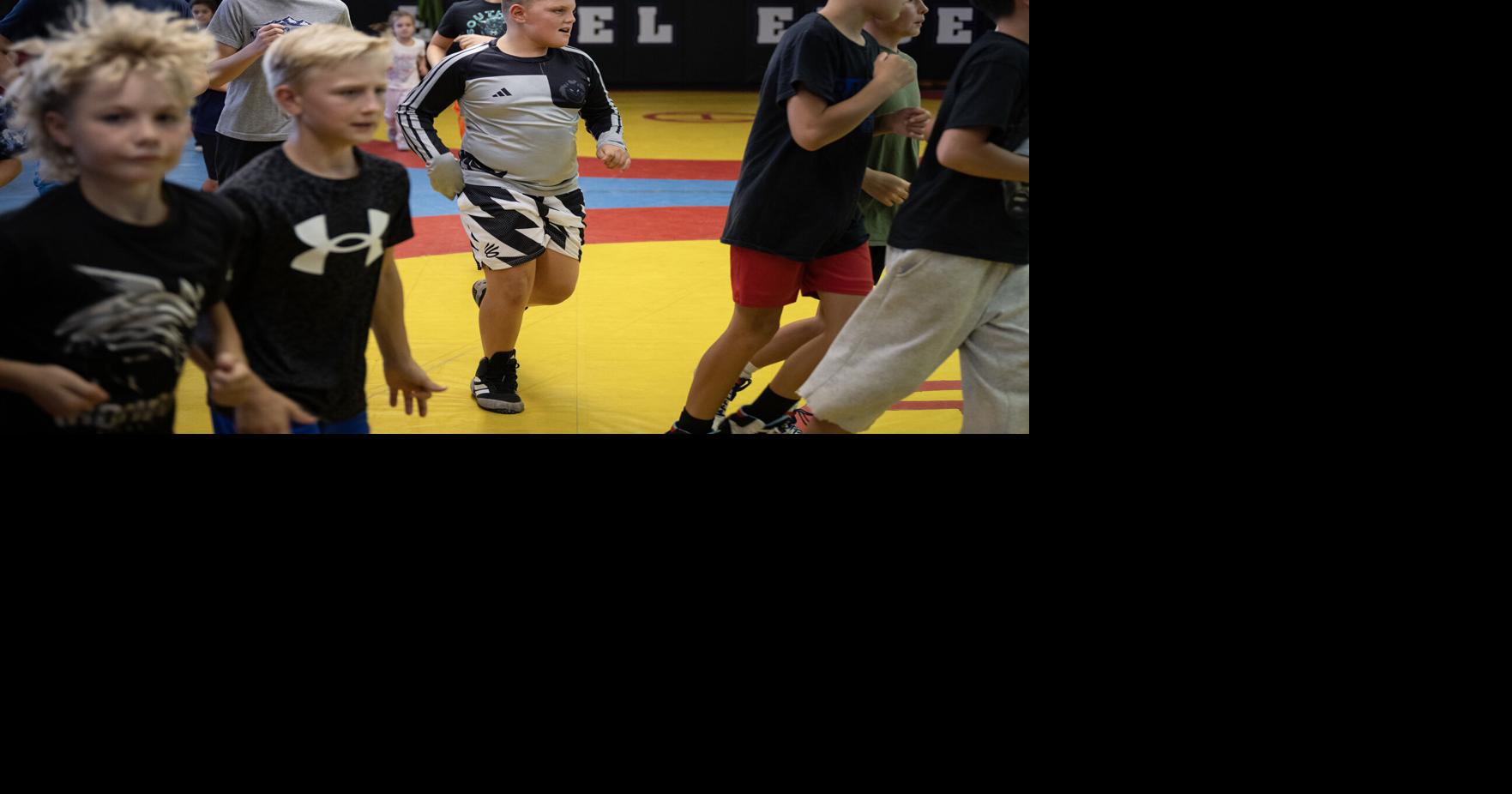 Vinny Amorosa, 10, center does laps with other wrestlers during a practice at Black Fox Wrestling Academy on Wednesday, Aug. 19, 2026, in Franktown, Colo..