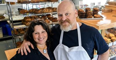 Man and woman smiling in shop - Night Work Bread Bakery