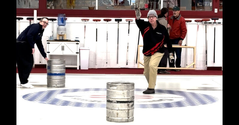A Schenectady Curling Club member sends a keg down the ice